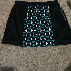 Black mini skirt with printed panels on front and back.
